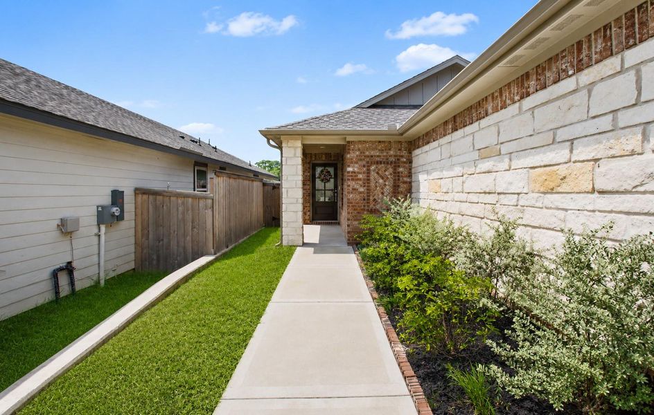 The long paved walkway leading to the front door gives a nice manicured touch to the front entrance. The long paved walkway leading to the front door gives a nice manicured touch to the front entrance.