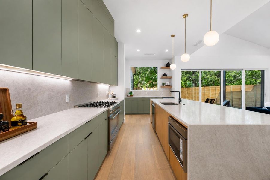 Culinary excellence awaits in this kitchen, boasting pristine countertops, abundant cabinetry, and integrated appliances.