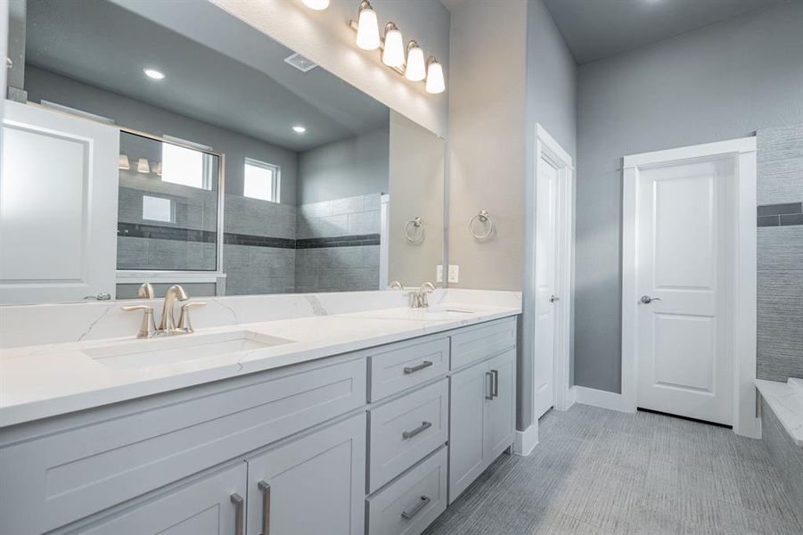 Bathroom with double vanity, a sink, a walk in shower, and recessed lighting Bathroom with double vanity, a sink, a walk in shower, and recessed lighting