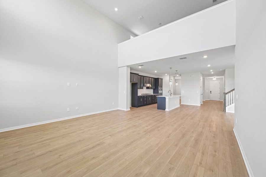 Off the kitchen is the spacious two-story great room which opens up to the upstairs loft space