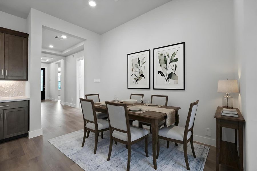 Create lasting memories around the table with family and friends in the breakfast nook! It showcases high ceilings, recessed lighting, and laminate flooring for a warm and welcoming atmosphere. *Virtually Staged