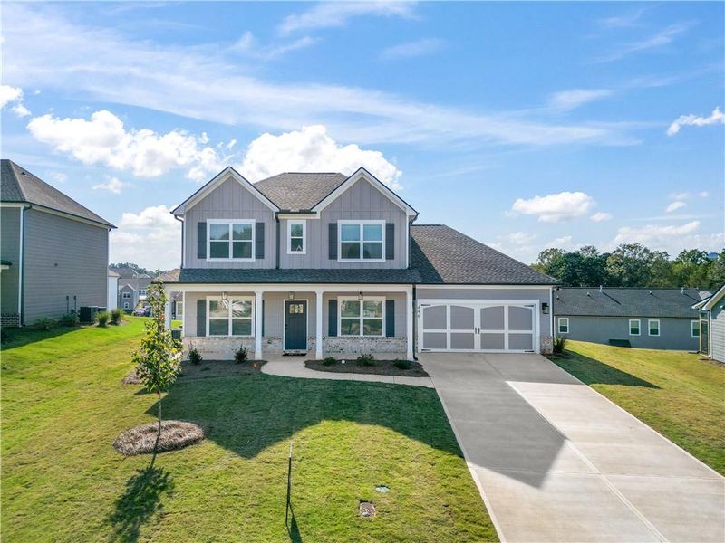Front exterior of a new home in Calgary Downs, Winder, GA, highlighting curb appeal (Image 1).