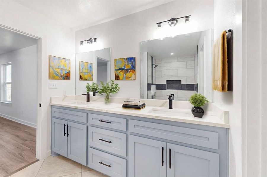 Bathroom with tiled shower, vanity, and hardwood / wood-style flooring