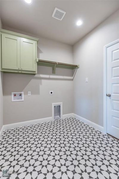 Washroom featuring hookup for an electric dryer, washer hookup, recessed lighting, light floors, and cabinet space