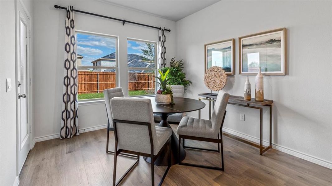 Interior space featuring wood-finish flooring, light grey walls, and white baseboards Interior space featuring wood-finish flooring, light grey walls, and white baseboards