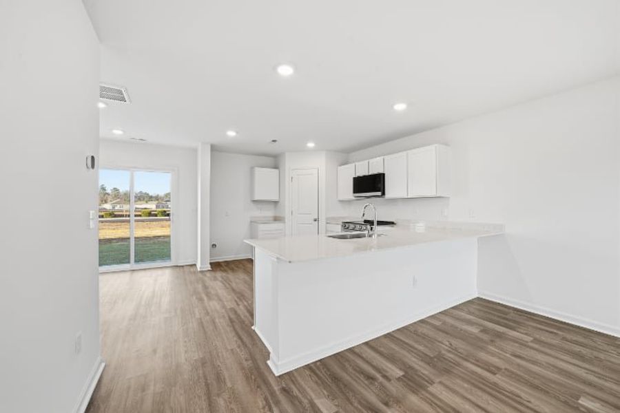 A kitchen with white cabinets.