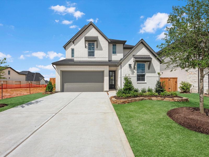 Front exterior of a new home in Pecan Ridge, Fulshear, TX, highlighting curb appeal (Image 2). Front exterior of a new home in Pecan Ridge, Fulshear, TX, highlighting curb appeal (Image 2).