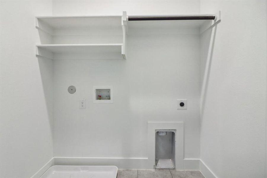 Laundry area featuring washer hookup, hookup for a gas dryer, hookup for an electric dryer, and light tile patterned floors