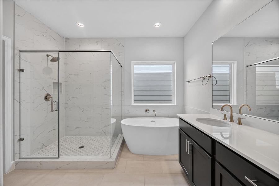 Spa-Like Primary Bathroom – Indulge in luxury with a freestanding soaking tub, herringbone-tiled shower, and double vanities with quartz countertops.