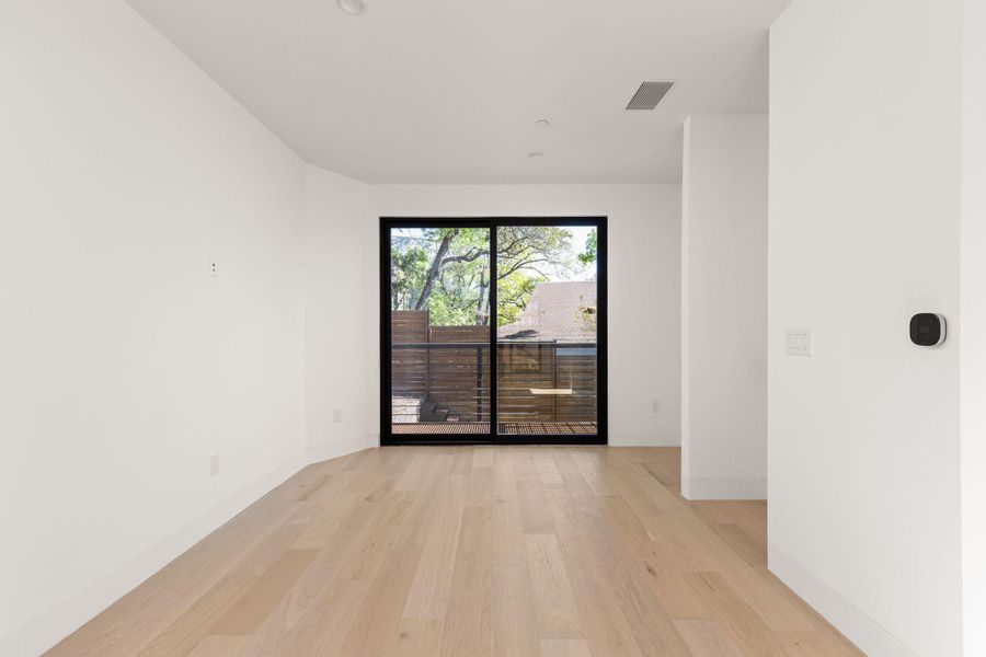 Empty room featuring light wood finished floors and baseboards