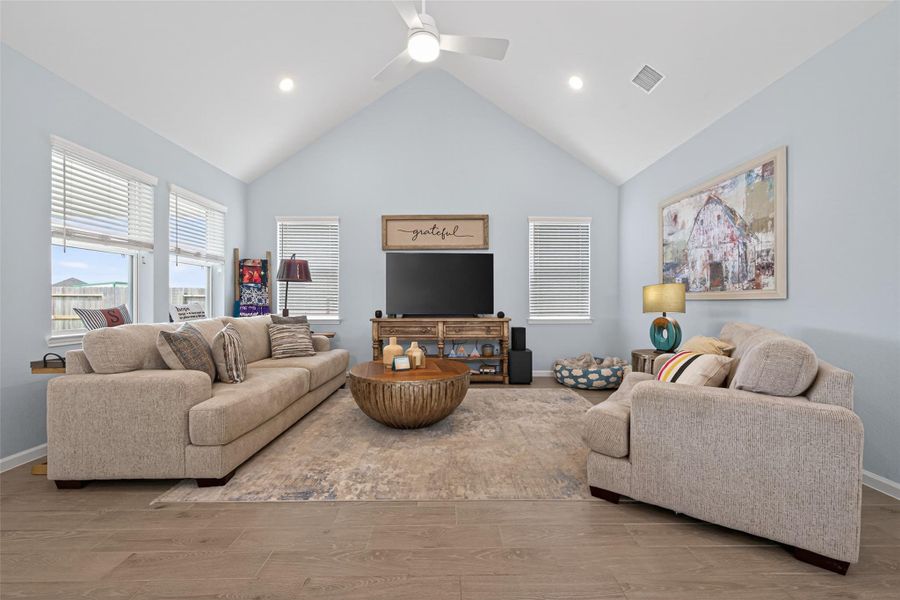 Spacious living area with vaulted ceilings and abundant natural light