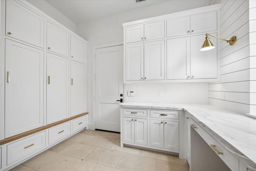 Mud room just off garage with lockers and command center/work space. Pictured April 2026.