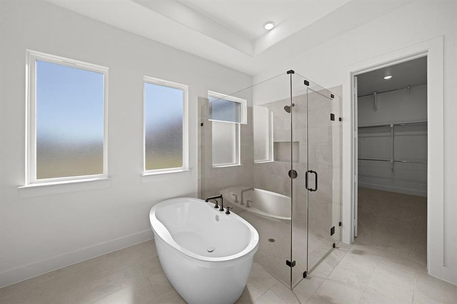 Bathroom with a freestanding tub, a spacious closet, a shower stall, and tile patterned flooring Bathroom with a freestanding tub, a spacious closet, a shower stall, and tile patterned flooring