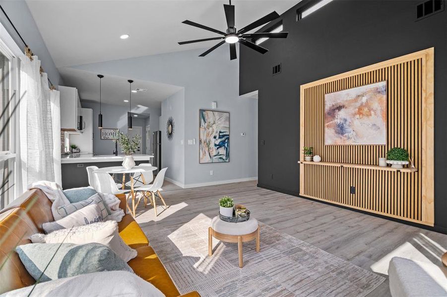 Living area with ceiling fan, recessed lighting, light wood finished floors, and vaulted ceiling Living area with ceiling fan, recessed lighting, light wood finished floors, and vaulted ceiling