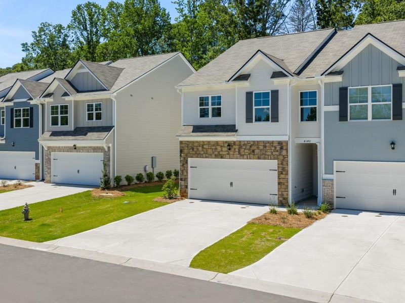 Front exterior of a new home in Falcon Landing Townhomes, Gainesville, GA, highlighting curb appeal (Image 1).