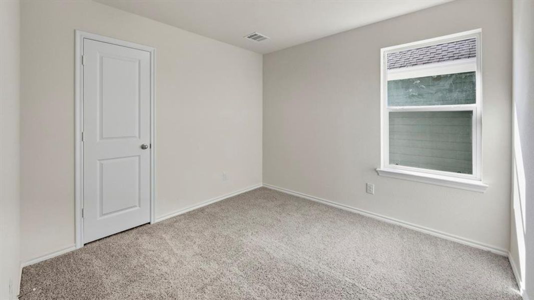 Carpeted empty room featuring baseboards