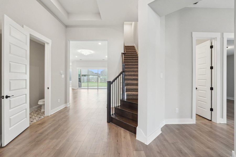 Stairs featuring wood finished floors and baseboards Stairs featuring wood finished floors and baseboards
