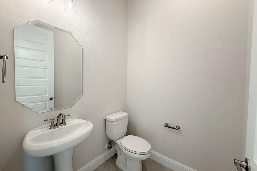 Bathroom featuring baseboards and toilet