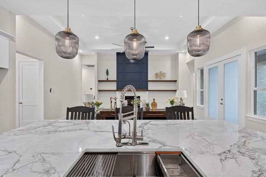 Kitchen island with marble-look countertop, integrated sink, and gooseneck faucet Kitchen island with marble-look countertop, integrated sink, and gooseneck faucet