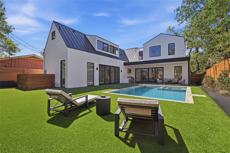 A private backyard oasis awaits with a sparkling pool, generous patio, and lush green space. A private backyard oasis awaits with a sparkling pool, generous patio, and lush green space.