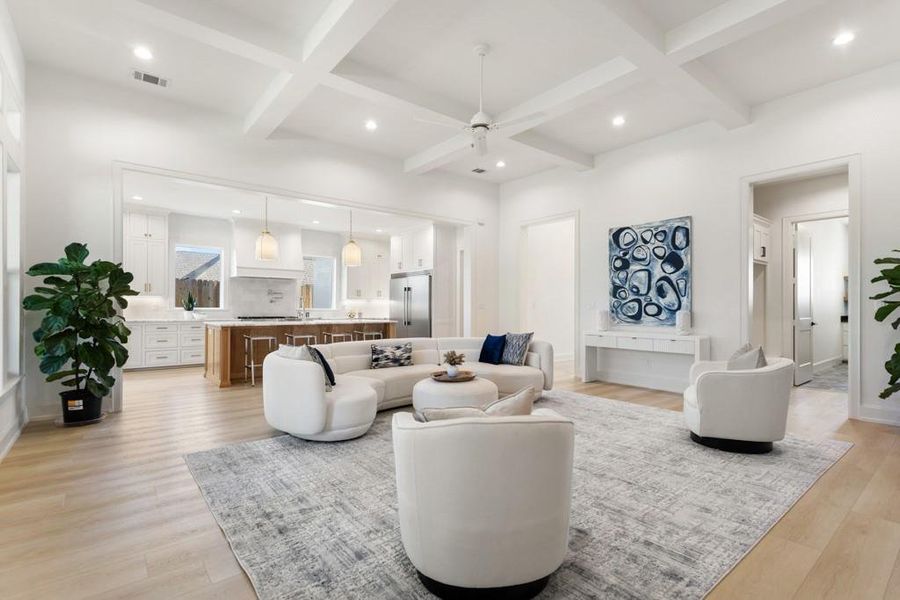 Living area with recessed lighting, beamed ceiling, a ceiling fan, coffered ceiling, and light wood-style floors