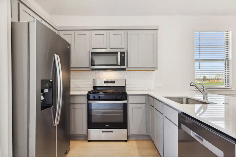 Kitchen in the Ash home plan by Trophy Signature Homes – REPRESENTATIVE PHOTO Kitchen in the Ash home plan by Trophy Signature Homes – REPRESENTATIVE PHOTO