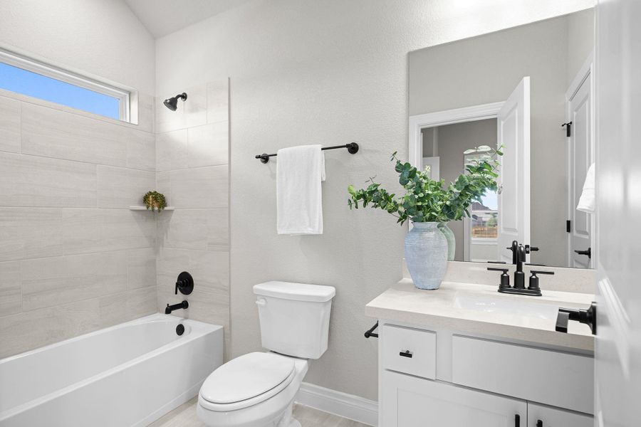 Bathroom featuring bathtub / shower combination and vanity