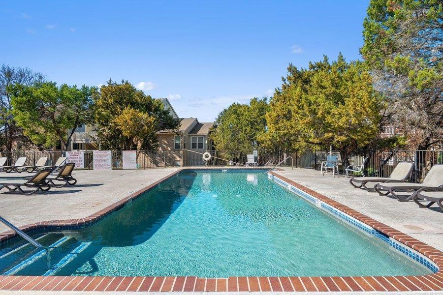 Community pool with a patio
