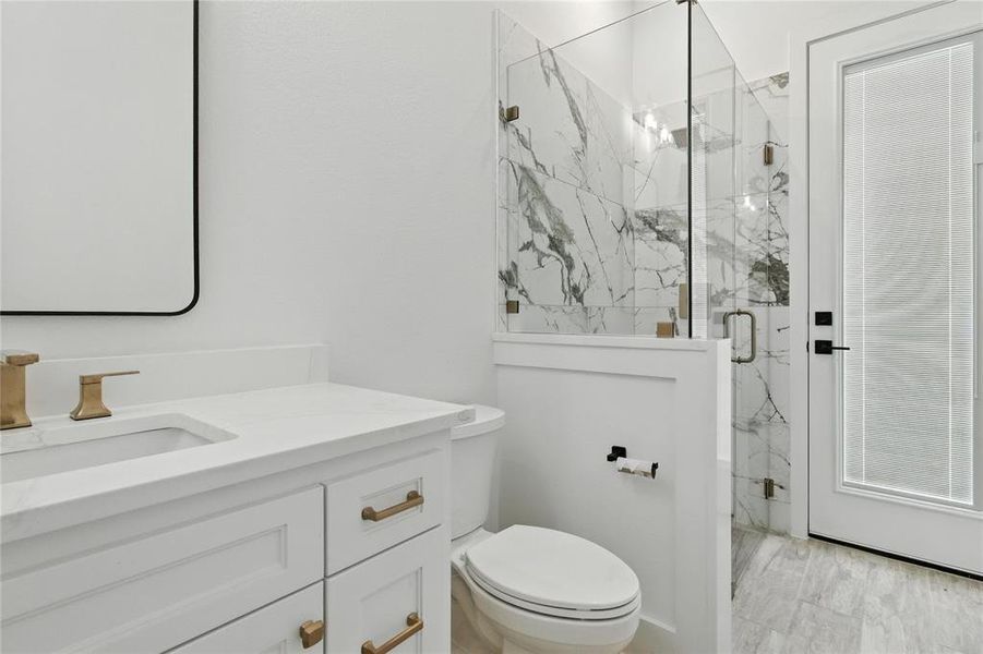Full bathroom featuring a marble finish shower and vanity Full bathroom featuring a marble finish shower and vanity