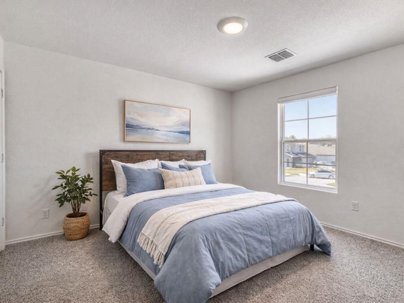 Carpeted bedroom featuring baseboards and a textured ceiling