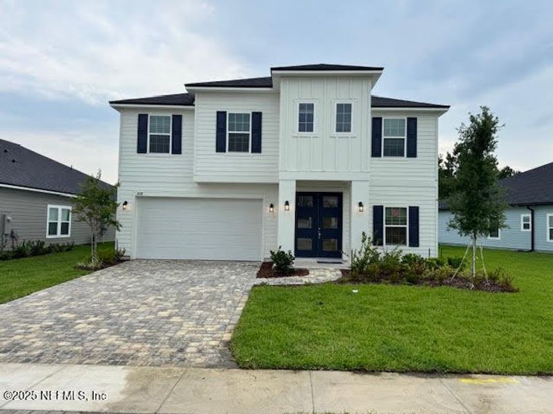 Front exterior of a new home in Silver Landing at SilverLeaf, St. Augustine, FL, highlighting curb appeal (Image 1). Front exterior of a new home in Silver Landing at SilverLeaf, St. Augustine, FL, highlighting curb appeal (Image 1).
