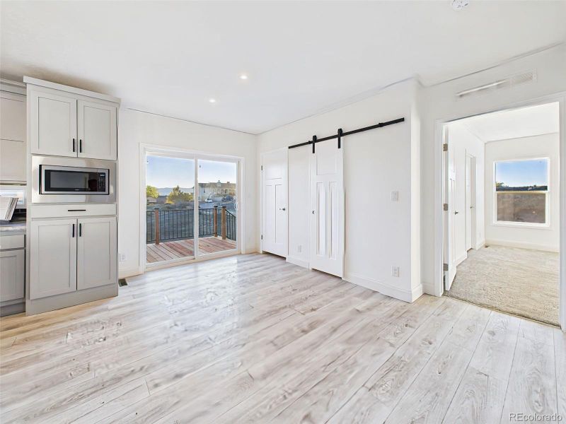 Bright dining area with sliding glass doors leading to the side west facing deck—perfect for indoor/outdoor dining BBQ and sunset views. Bright dining area with sliding glass doors leading to the side west facing deck—perfect for indoor/outdoor dining BBQ and sunset views.