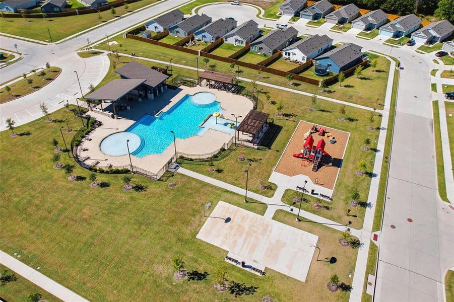 Aerial perspective of suburban area featuring a pool area Aerial perspective of suburban area featuring a pool area