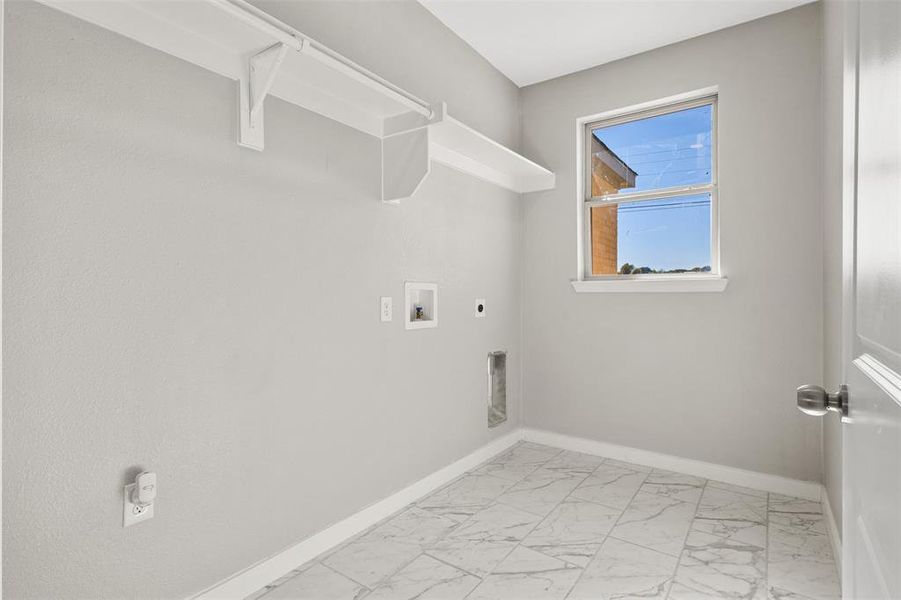 Laundry area with light marble finish flooring, hookup for an electric dryer, and hookup for a washing machine