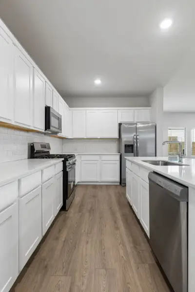 Kitchen in the Oscar home plan by Trophy Signature Homes – REPRESENTATIVE PHOTO Kitchen in the Oscar home plan by Trophy Signature Homes – REPRESENTATIVE PHOTO