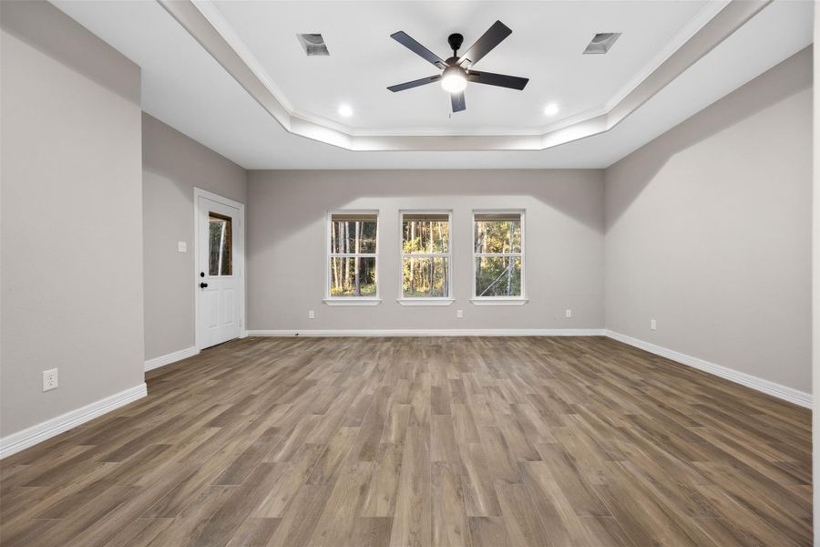 Sample of Home. Primary bedroom with back door exit to patio