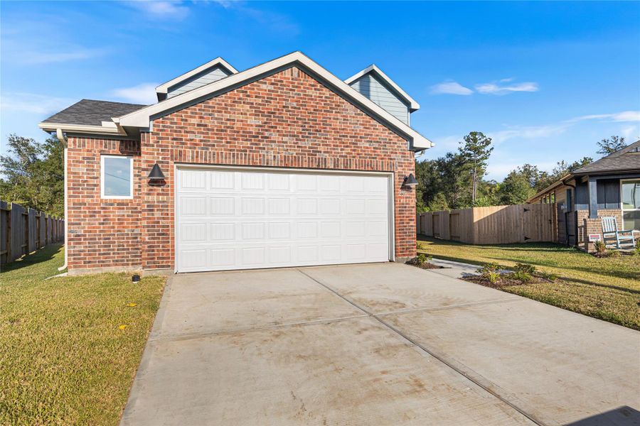 Front exterior of a new home in Hill & Dale Ranch, Splendora, TX, highlighting curb appeal (Image 19).