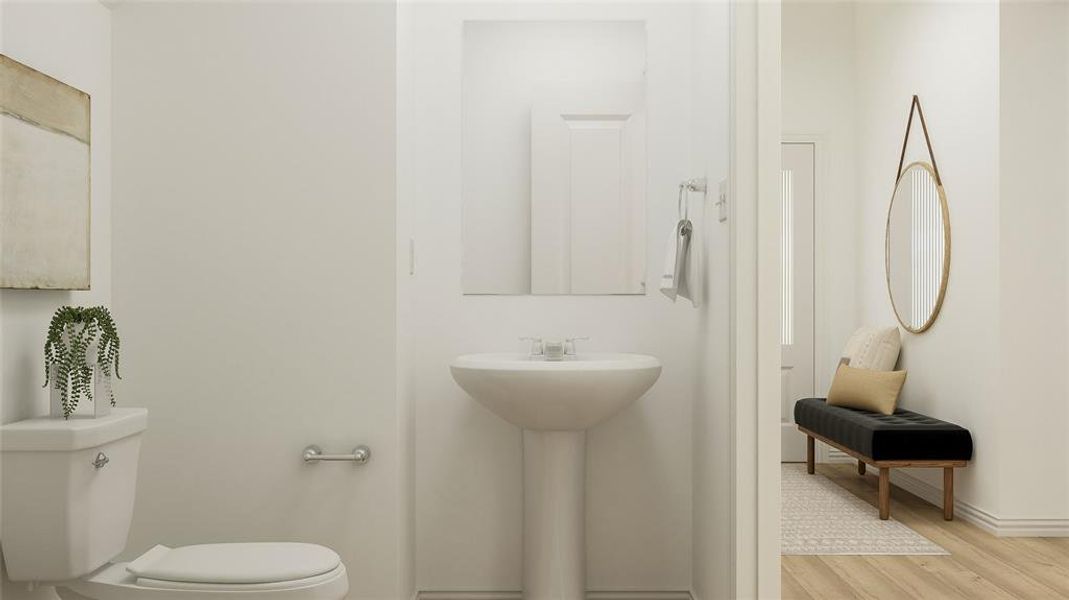 Bathroom with hardwood / wood-style floors, sink, and toilet