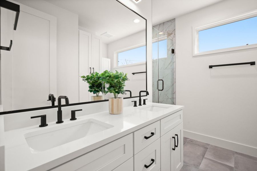 Ensuite primary bathroom with dual vanities