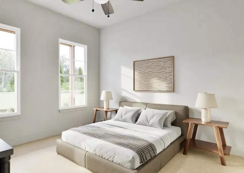 Minimalist bedroom with a large bed featuring white linens and a gray throw. Two wooden side tables with lamps are beside the bed. Sunlight streams through two windows on the left, creating a peaceful, airy feel. A framed artwork hangs above the bed.