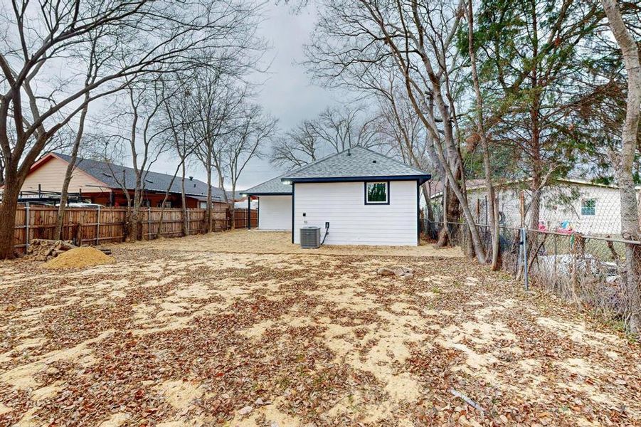 Rear view of house featuring cooling unit