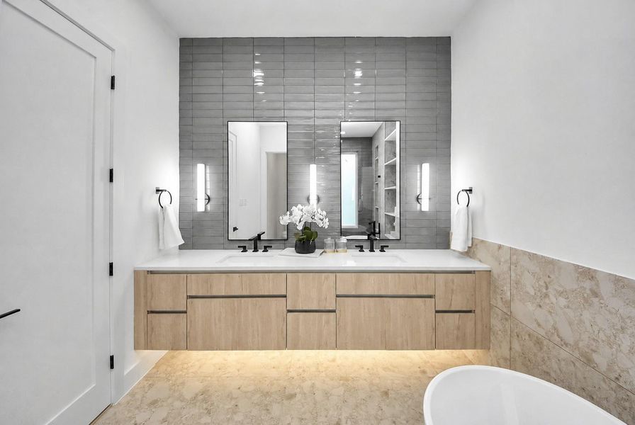 Primary bathroom with a spacious double vanity and modern black fixtures.