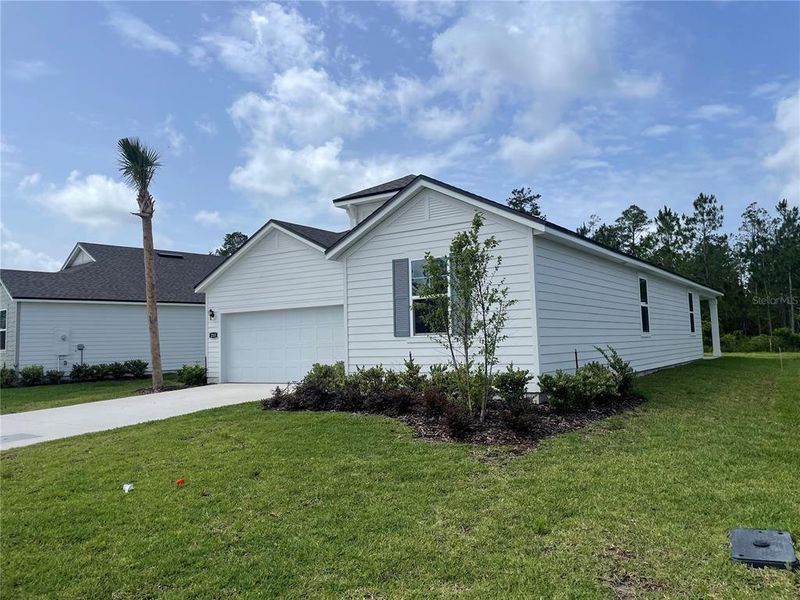 Front exterior of a new home in Magnolia Series at Seminole Palms, Palm Coast, FL, highlighting curb appeal (Image 27).