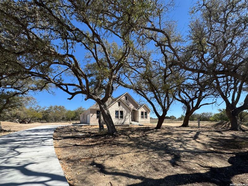 Front exterior of a new home in Waldsanger, New Braunfels, TX, highlighting curb appeal (Image 1). Front exterior of a new home in Waldsanger, New Braunfels, TX, highlighting curb appeal (Image 1).