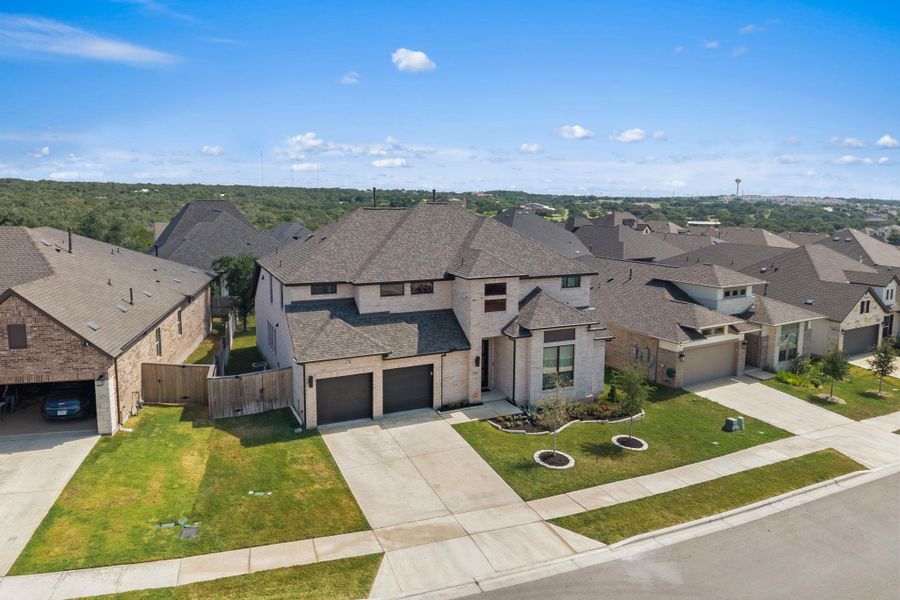Two-story residence showcasing a well-maintained lawn and a convenient attached garage. Two-story residence showcasing a well-maintained lawn and a convenient attached garage.