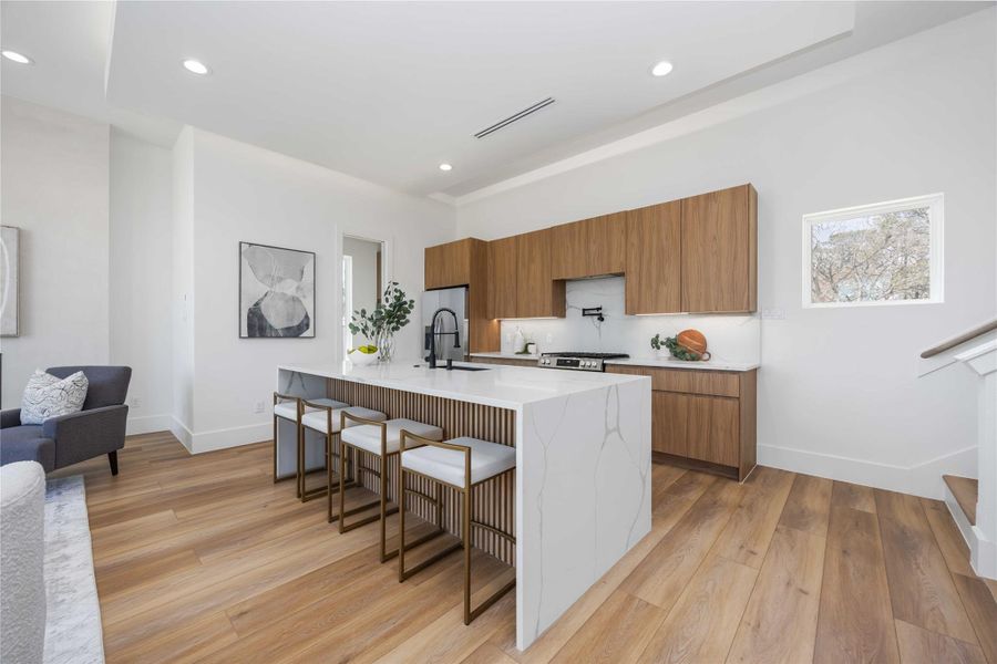 Kitchen includes walk-in pantry featuring built-in appliances including a microwave and oven, along with ample shelving for organization.