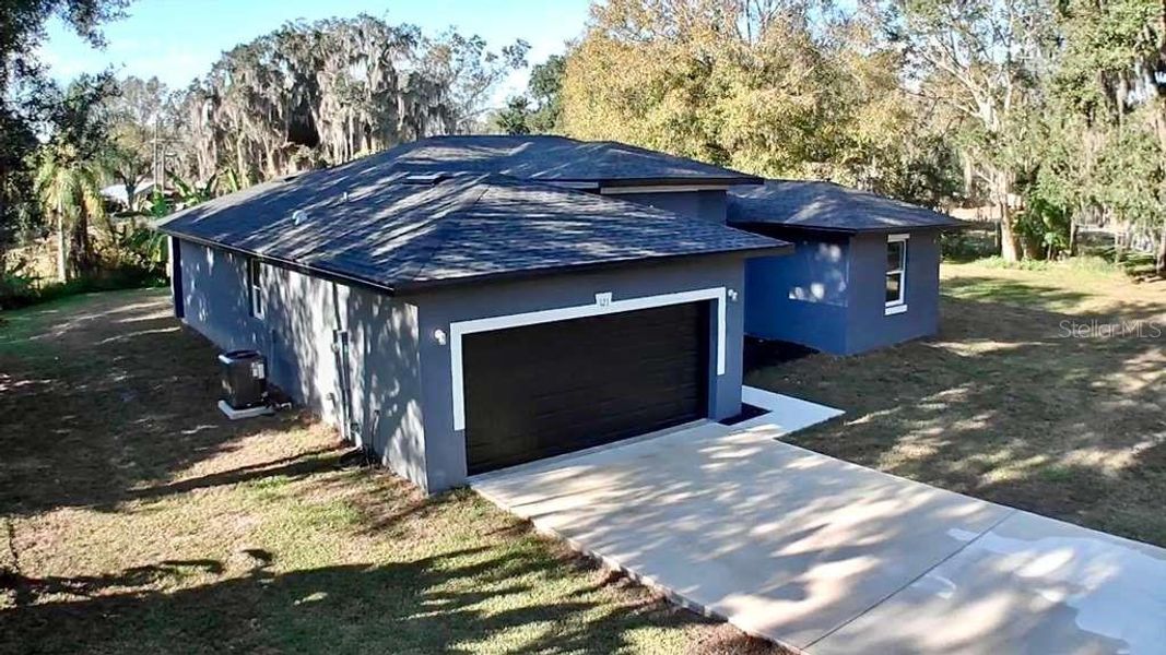 Front exterior of a new home in , Frostproof, FL, highlighting curb appeal (Image 16).