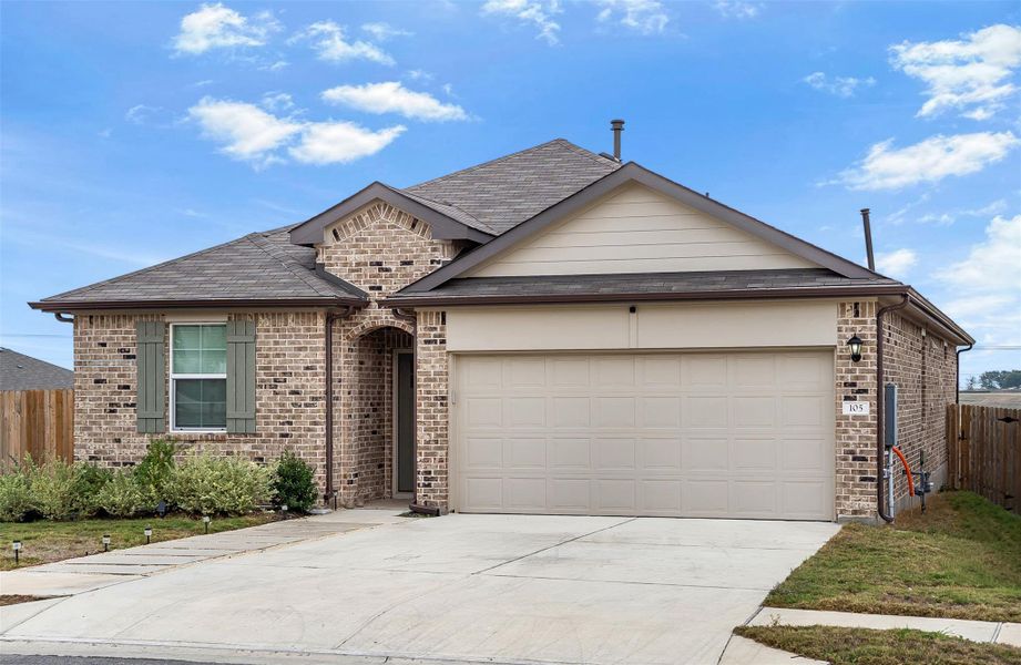 View of front facade featuring brick siding, driveway, an attached garage, and a shingled roof View of front facade featuring brick siding, driveway, an attached garage, and a shingled roof