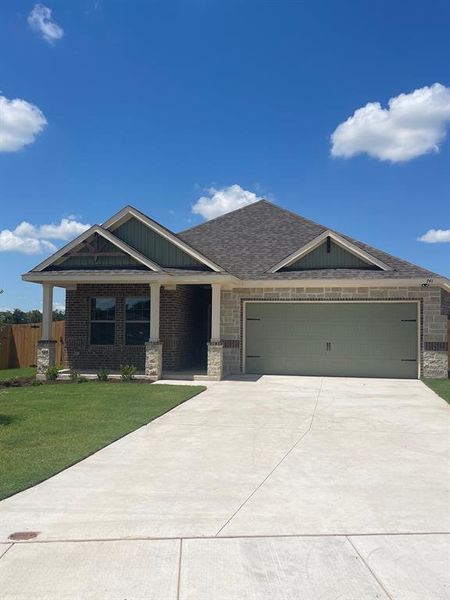 Craftsman house with a front lawn and a garage