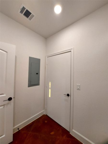 Another view of the laundry room showing the door that enters into the kitchen and the other door enters the garage.